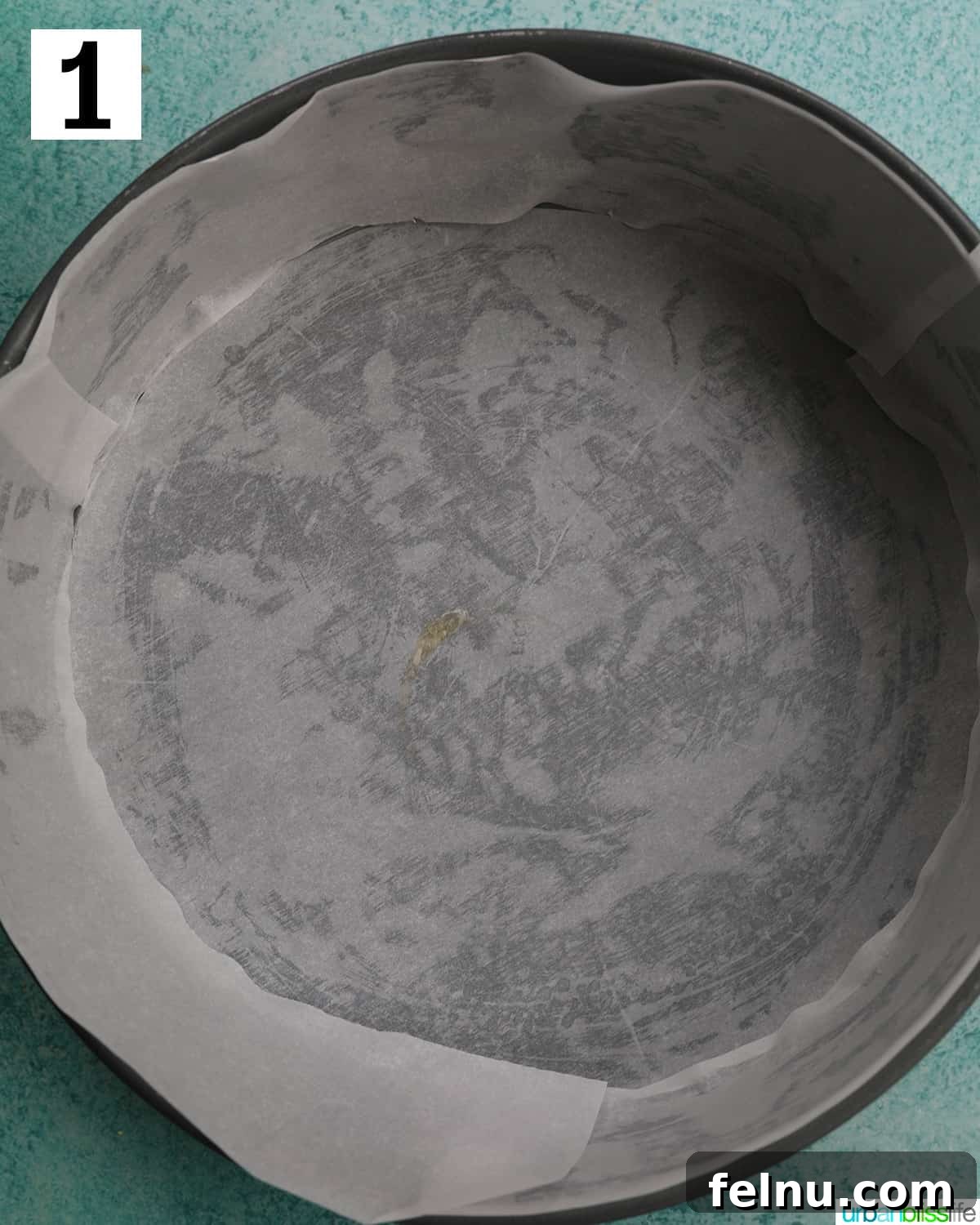 Easter Egg Delight Cheesecake 9 Greasing a springform pan with parchment paper.