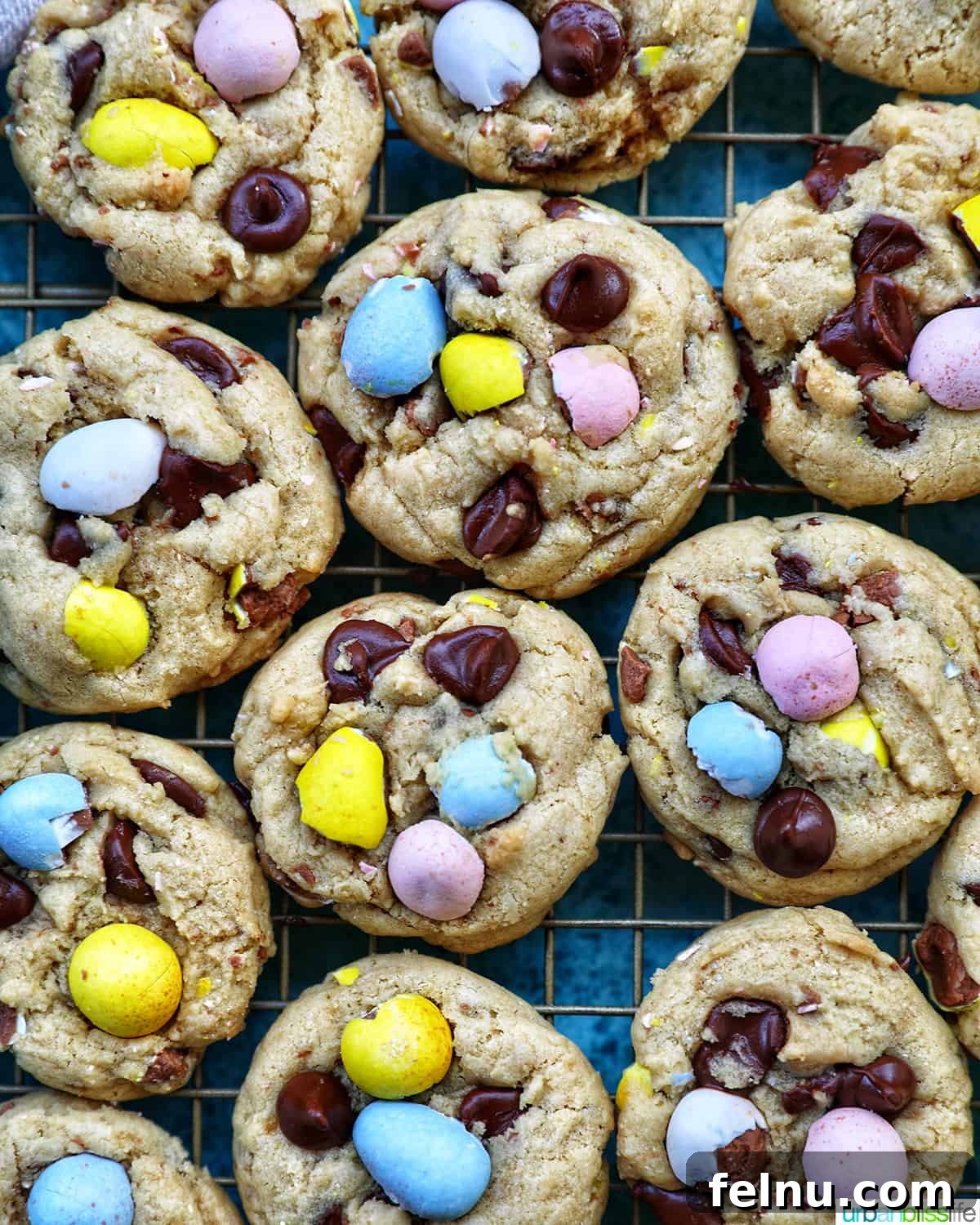Effortless Mini Egg Cookies 3 Neatly arranged rows of freshly baked Easter mini egg cookies cooling on a wire rack, showcasing their perfect golden-brown finish.