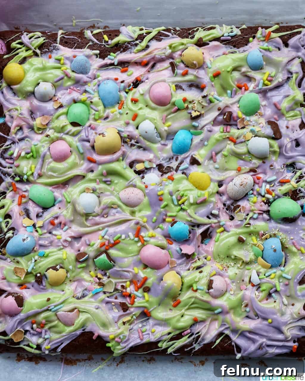 Easter Chocolate Squares 20 Overhead view of decorated Easter brownies showcasing the colorful white chocolate swirls and candies.