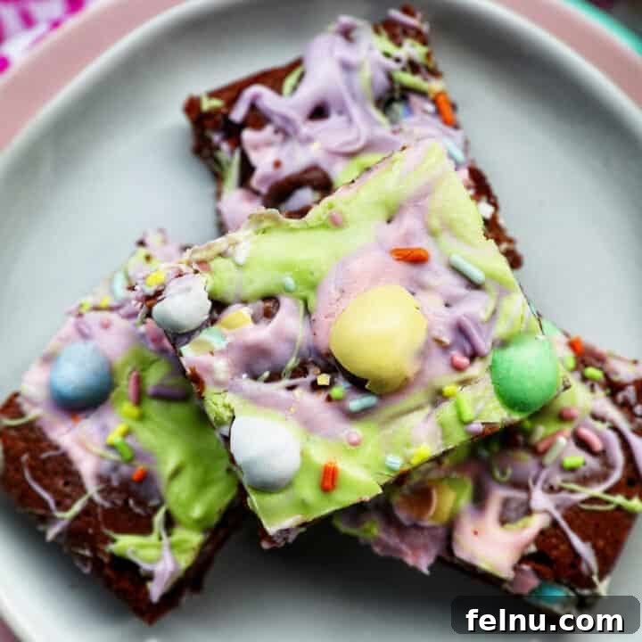 Easter brownies stacked on a plate, showcasing their colorful toppings.