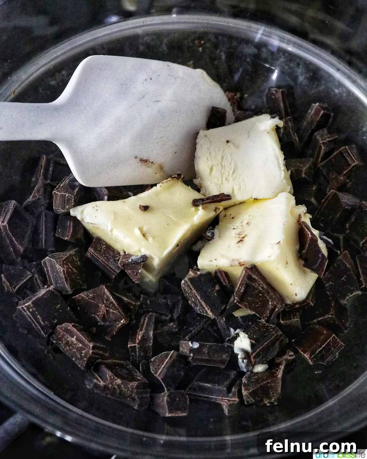 Easter Chocolate Squares 7 Melting chocolate with butter in a double boiler or heatproof bowl over a saucepan.
