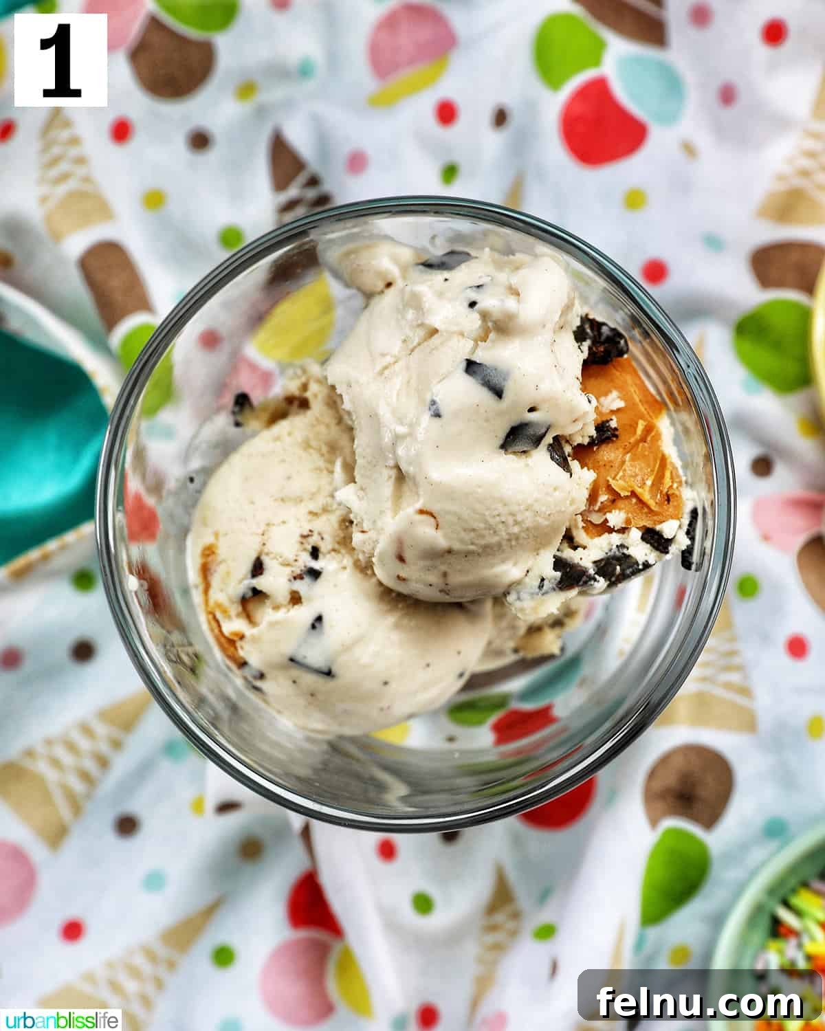 Ice Cream Parfait: A Symphony of Flavors and Textures 5 Scoops of ice cream elegantly placed in a parfait glass, resting on a colorful, fun kitchen towel.