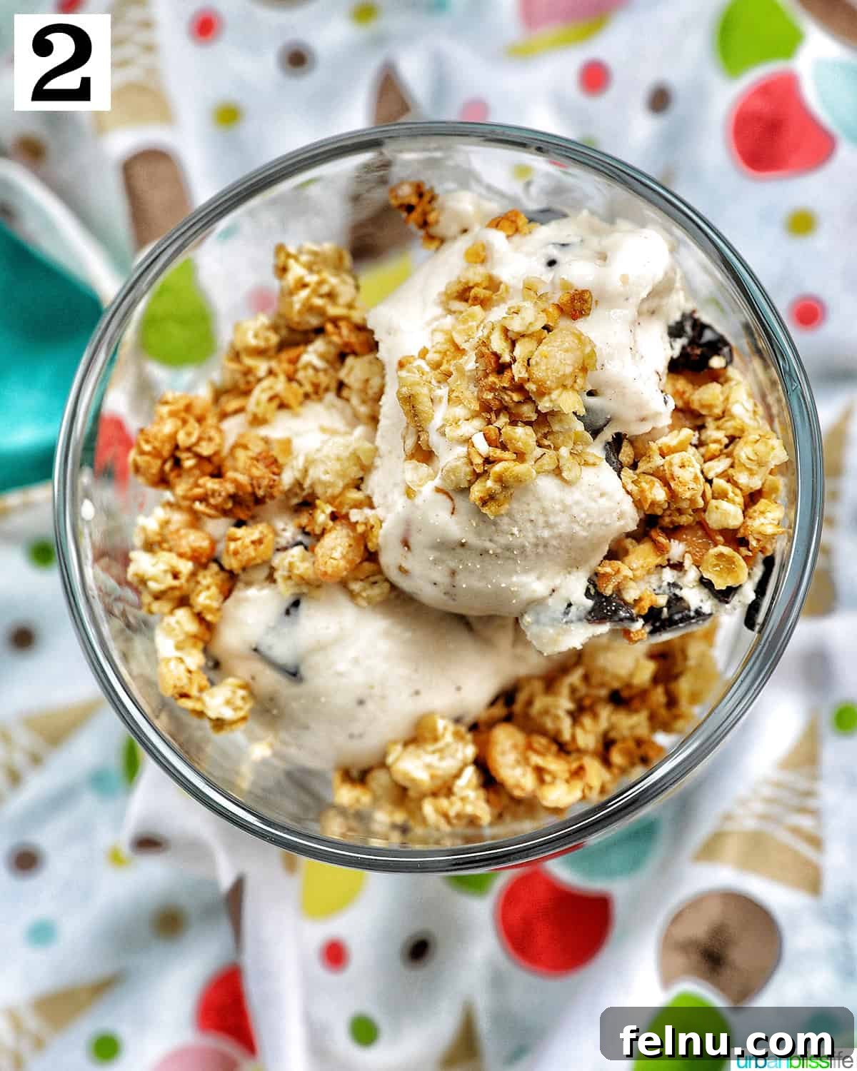 Ice Cream Parfait: A Symphony of Flavors and Textures 6 An ice cream parfait, topped with granola, beautifully presented on a colorful kitchen towel.