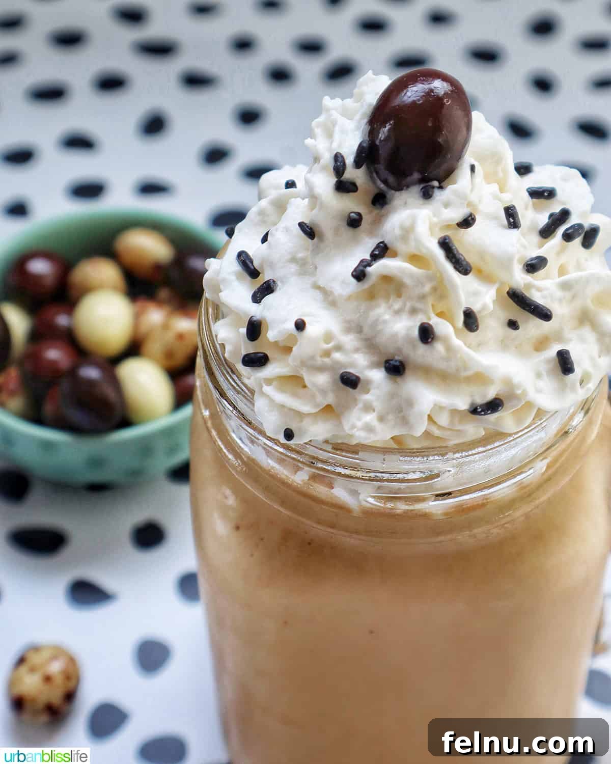 Coffee Milkshake in a mason jar mug with whipped cream and chocolate covered espresso beans