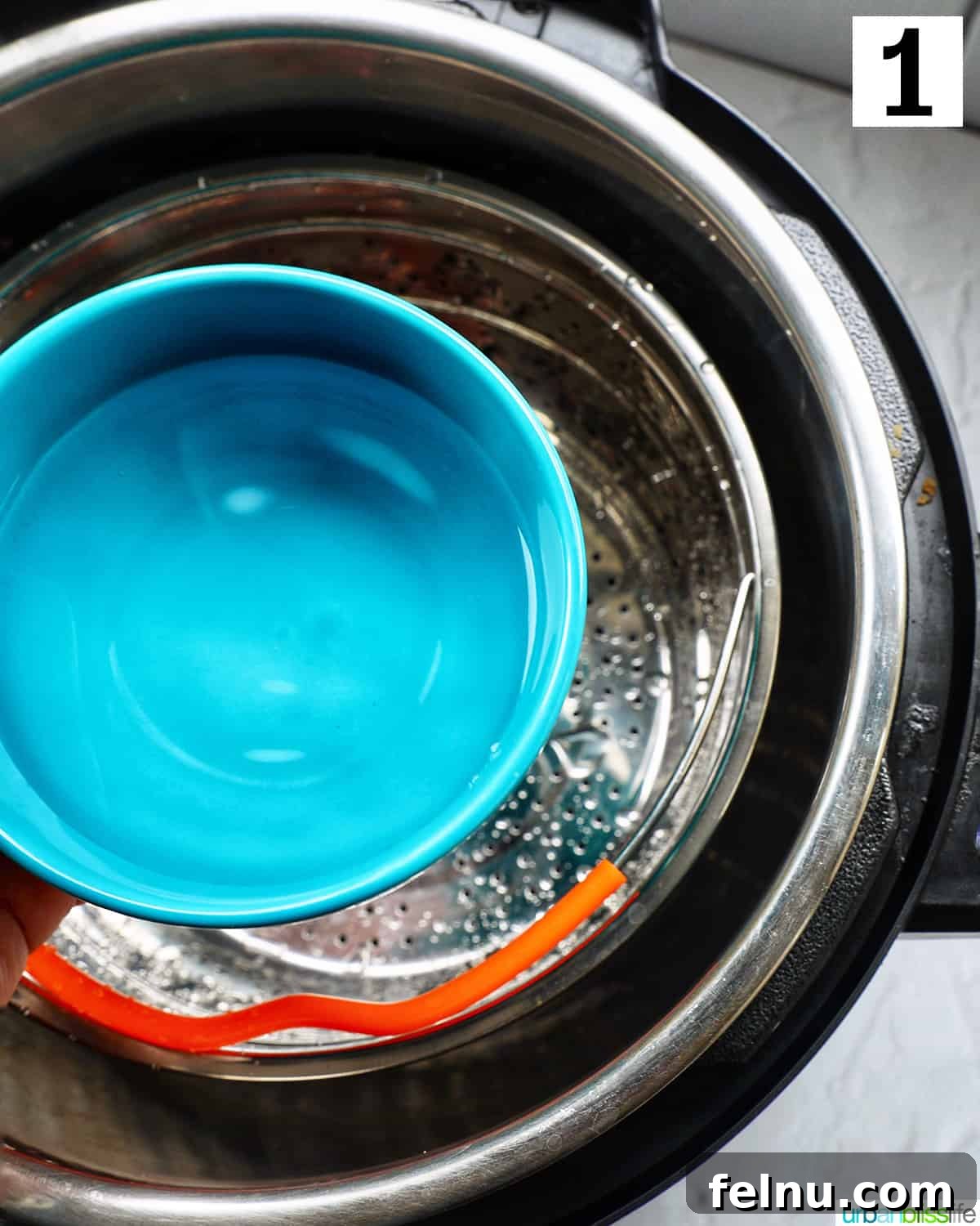 Adding water to the Instant Pot with a steamer basket inside.
