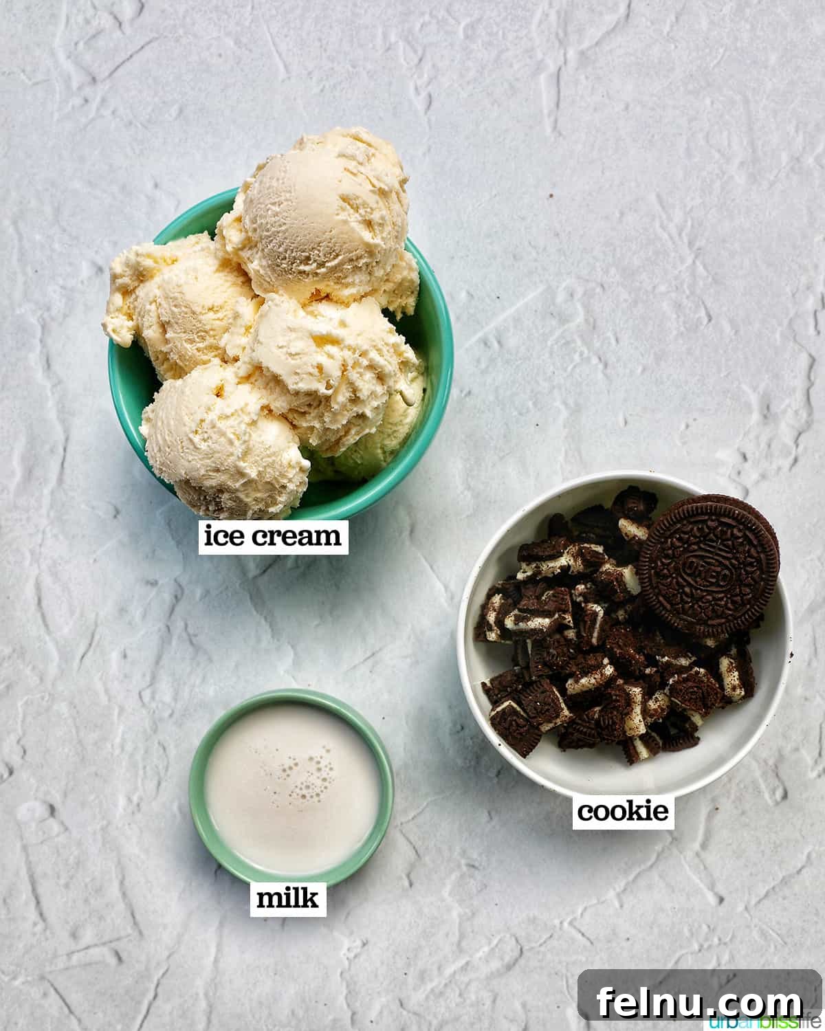 Creamy Dream: The 3-Ingredient Cookies and Cream Milkshake 4 Three bowls of ingredients: a bowl of vanilla ice cream, a glass of milk, and a bowl of crushed Oreo cookies, ready to make cookies and cream milkshakes.