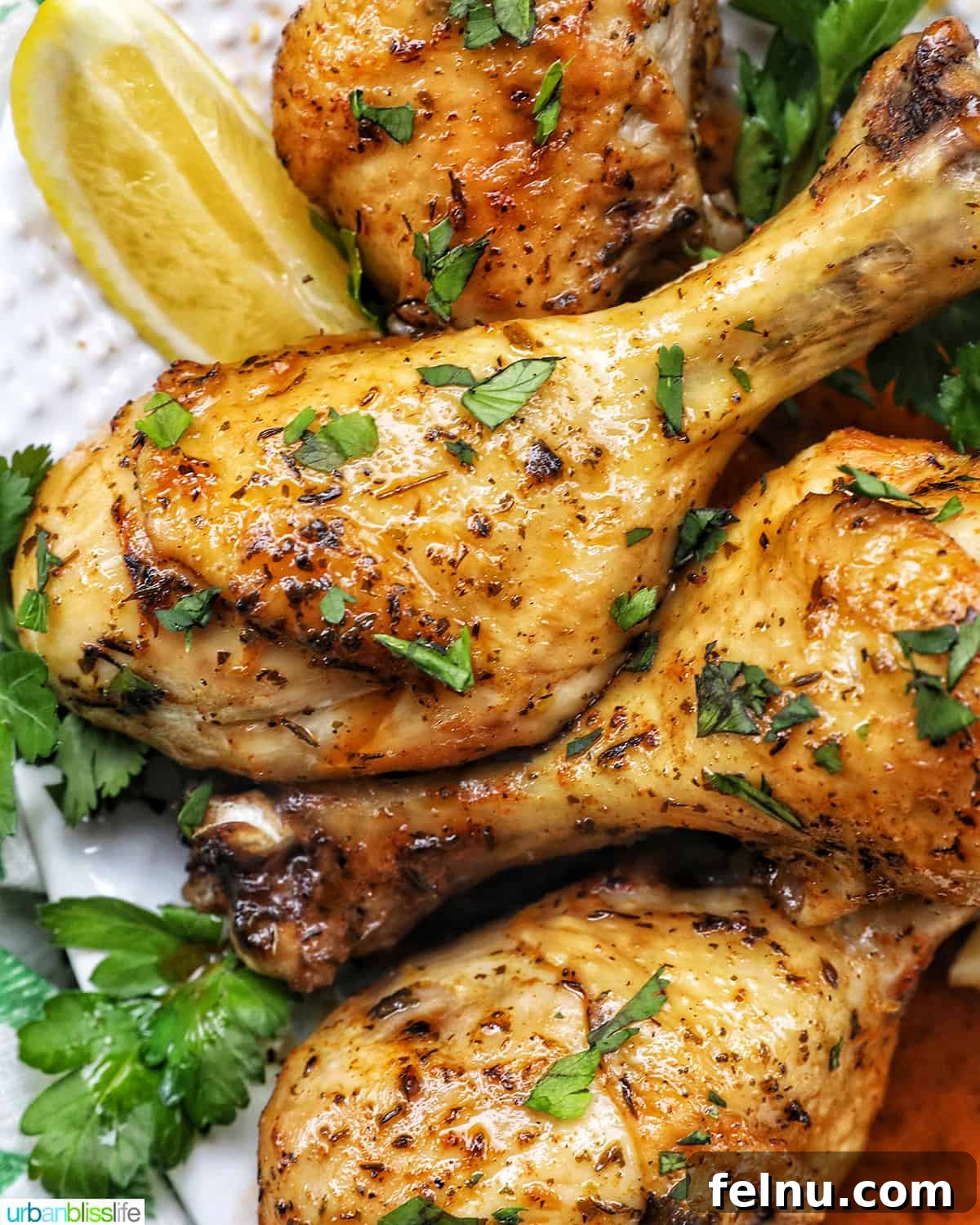Instant Pot Chicken Legs 2 Instant Pot Chicken Drumsticks: Seasoned and garnished with parsley and lemon wedges.