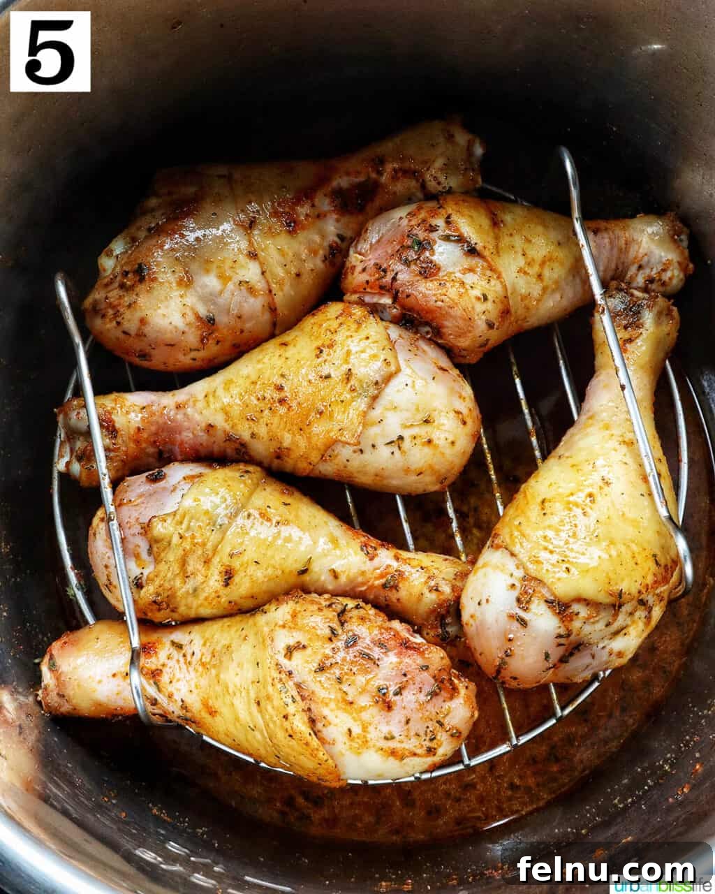 Instant Pot Chicken Legs 13 Chicken drumsticks on a trivet in the Instant Pot.