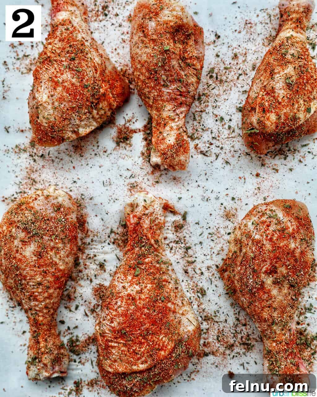 Instant Pot Chicken Legs 7 Seasoned chicken drumsticks on parchment paper.