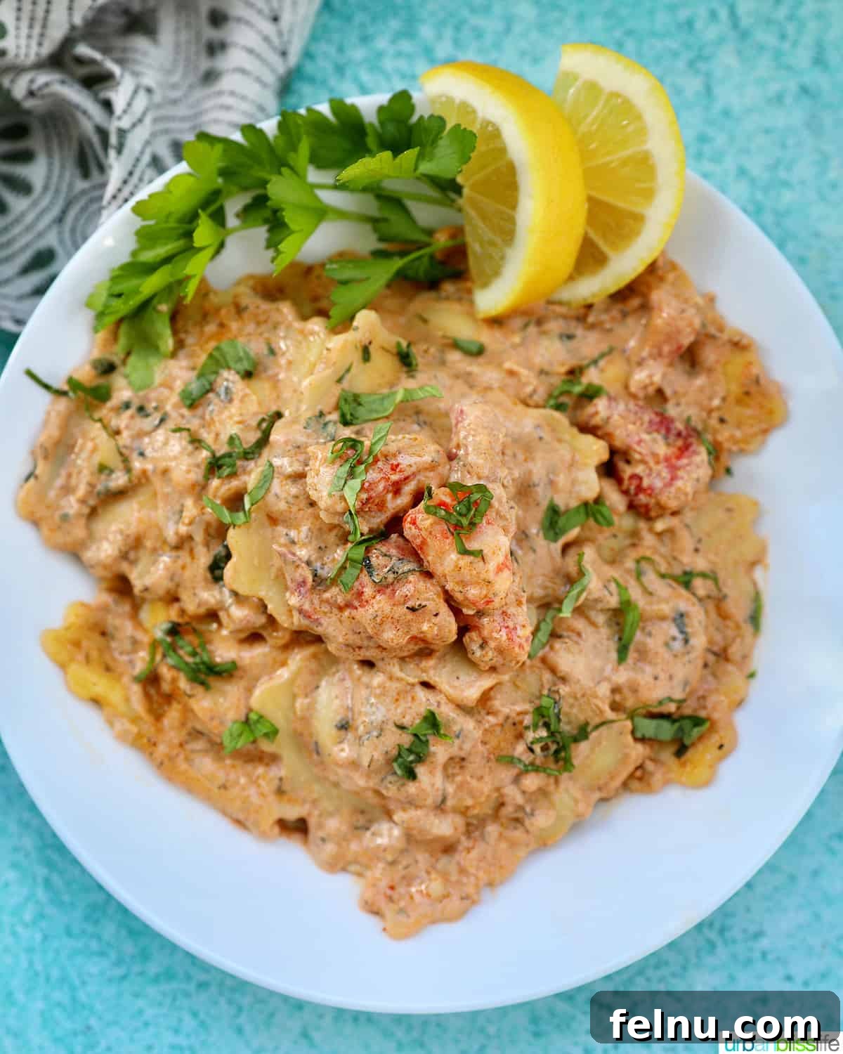 Lobster Ravioli Sauce served with lobster meat, lemon wedges, and herbs.