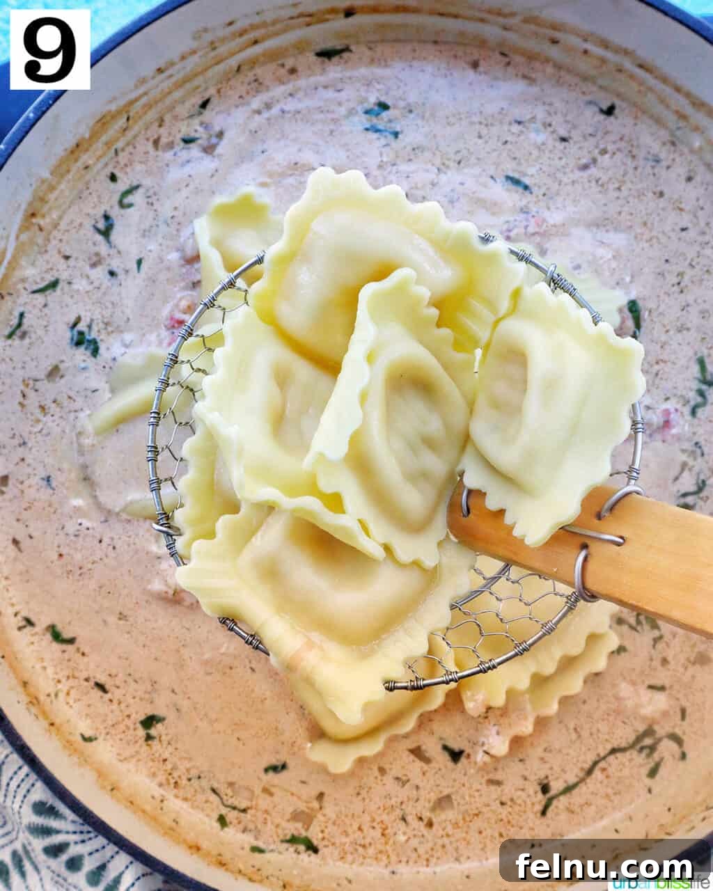 Adding cooked ravioli to the sauce.