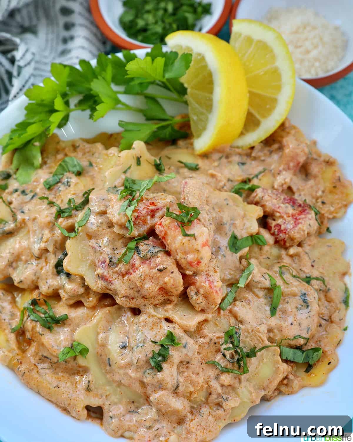 Close-up of Lobster Ravioli Sauce with lobster and lemon.