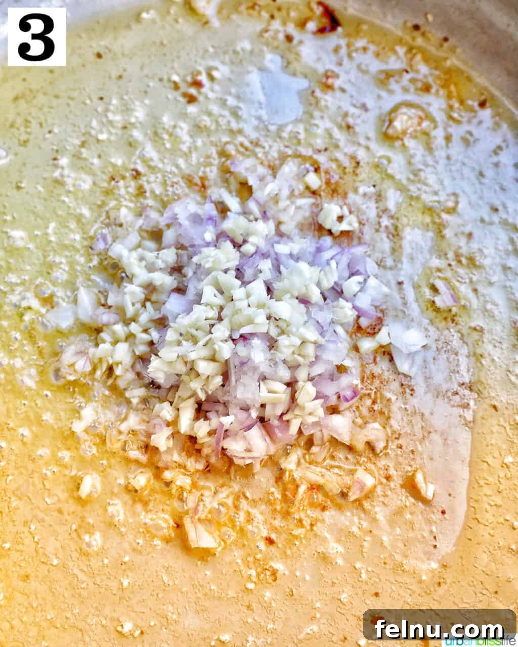Sauteing garlic and shallots in the pan.