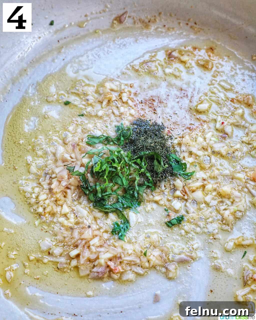 Adding fresh basil and dill to the pan.
