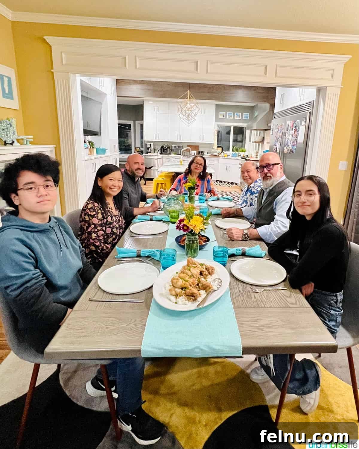 Dinner with the Jayme-Schotlands 2 Our family, including my parents, husband, and children, smiling happily with Chef Andrew Zimmern around our dinner table during the filming of Family Dinner TV show.