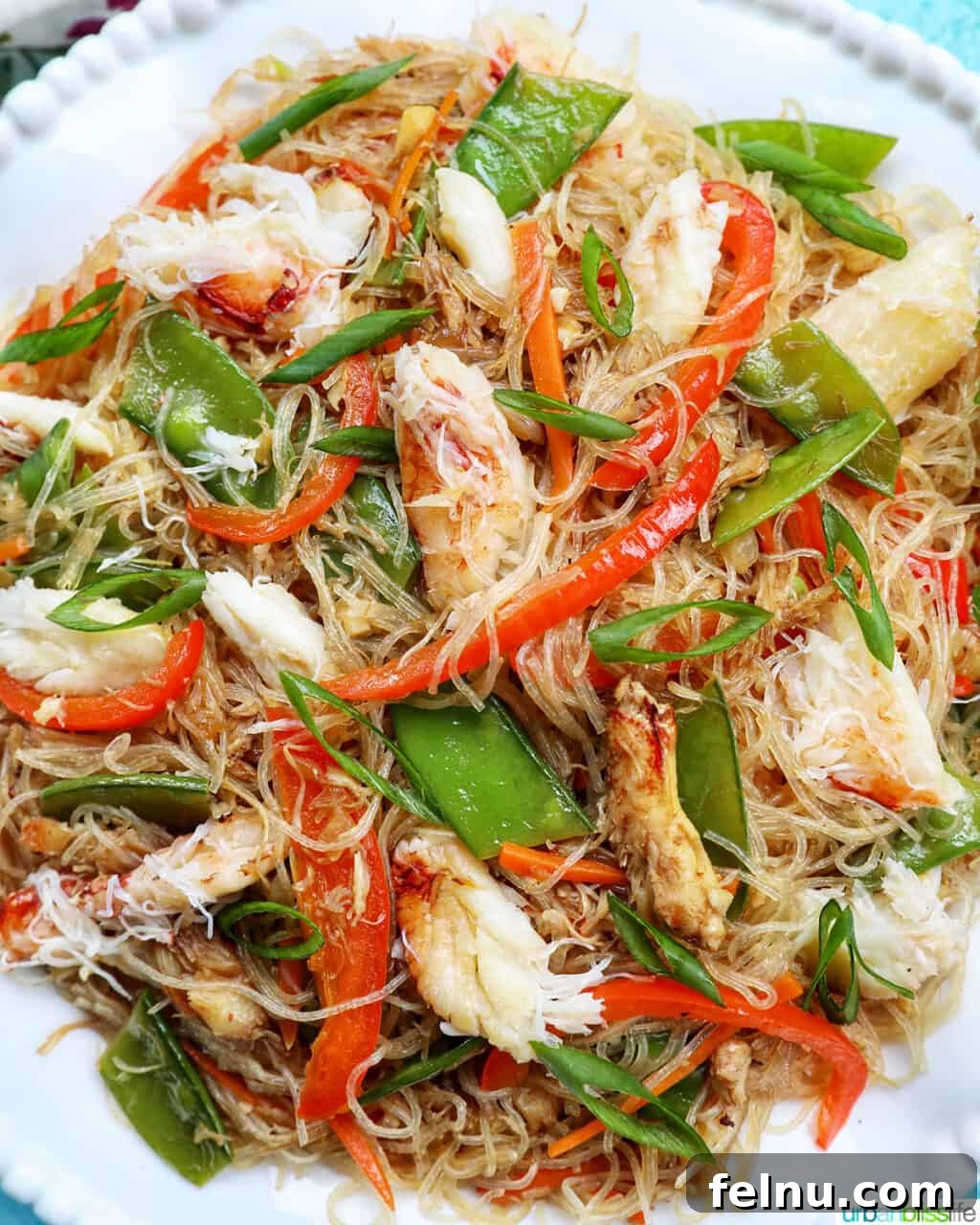 Dinner with the Jayme-Schotlands 12 A large bowl of delicious Crab Pancit Filipino noodles, generously topped with fresh vegetable slices and succulent chunks of Dungeness crab meat.