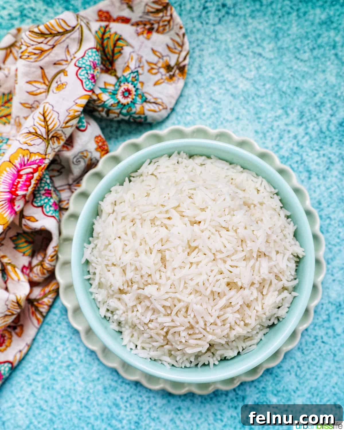 Fluffy Instant Pot Basmati Rice 8 white basmati rice in a blue bowl on green plate.