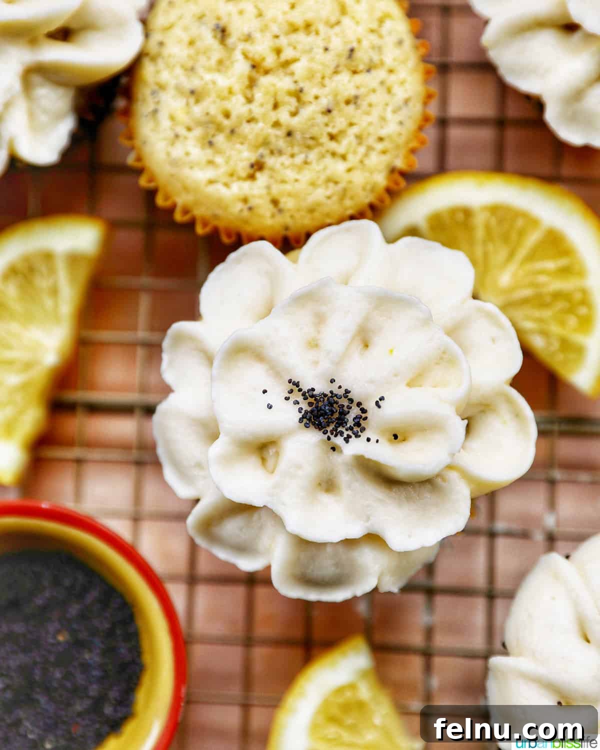 Lemon Poppy Seed Dream Cupcakes 3 Closeup of lemon poppyseed cupcakes decorated in lemon buttercream frosting shaped like a flower.