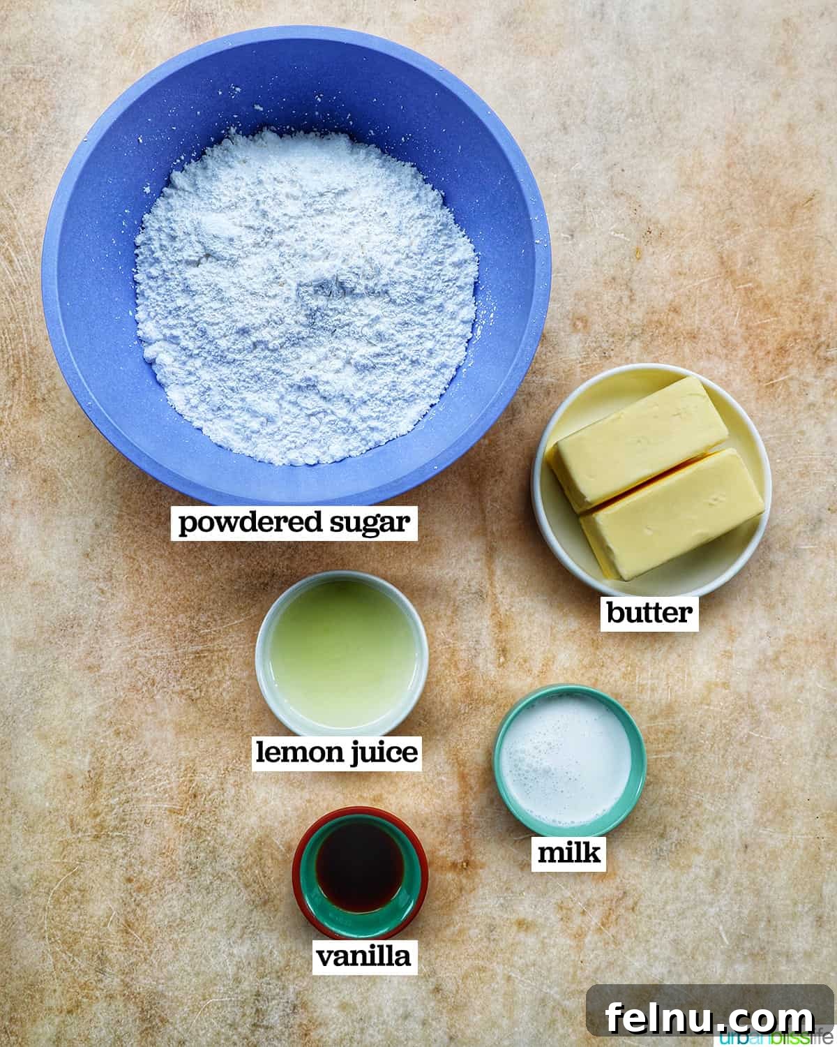 Lemon Poppy Seed Dream Cupcakes 5 Bowls of ingredients to make lemon buttercream frosting on a yellow background.