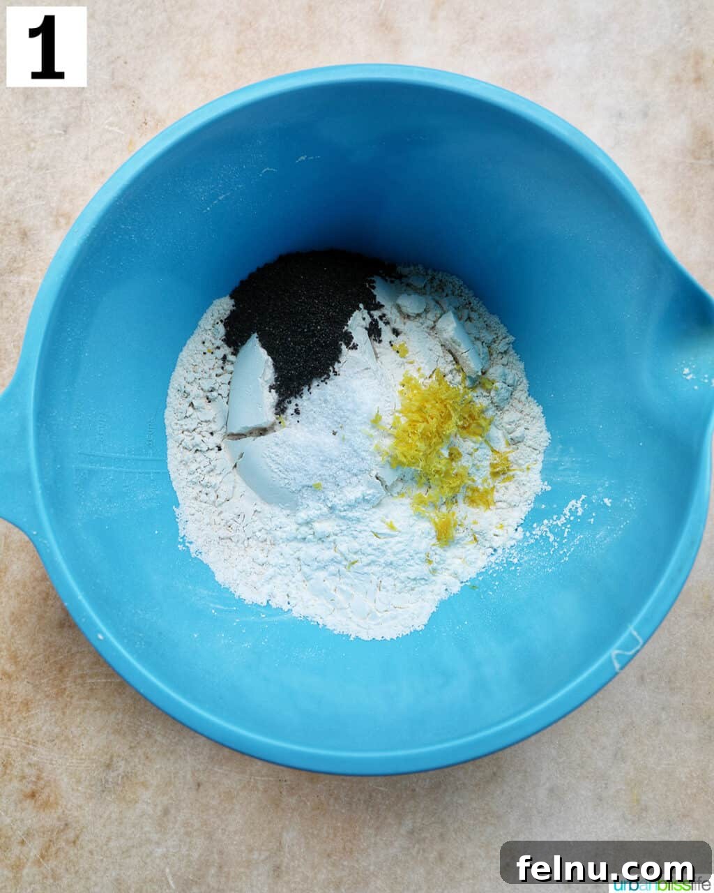 Lemon Poppy Seed Dream Cupcakes 6 Blue bowl with dry ingredients to make lemon poppyseed cupcakes.