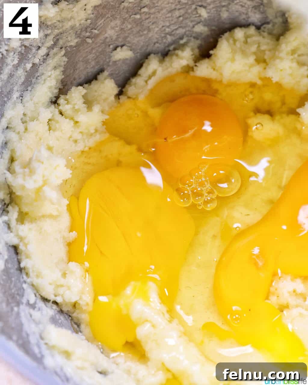 Lemon Poppy Seed Dream Cupcakes 9 Eggs added to cupcake batter in a stand mixer bowl.
