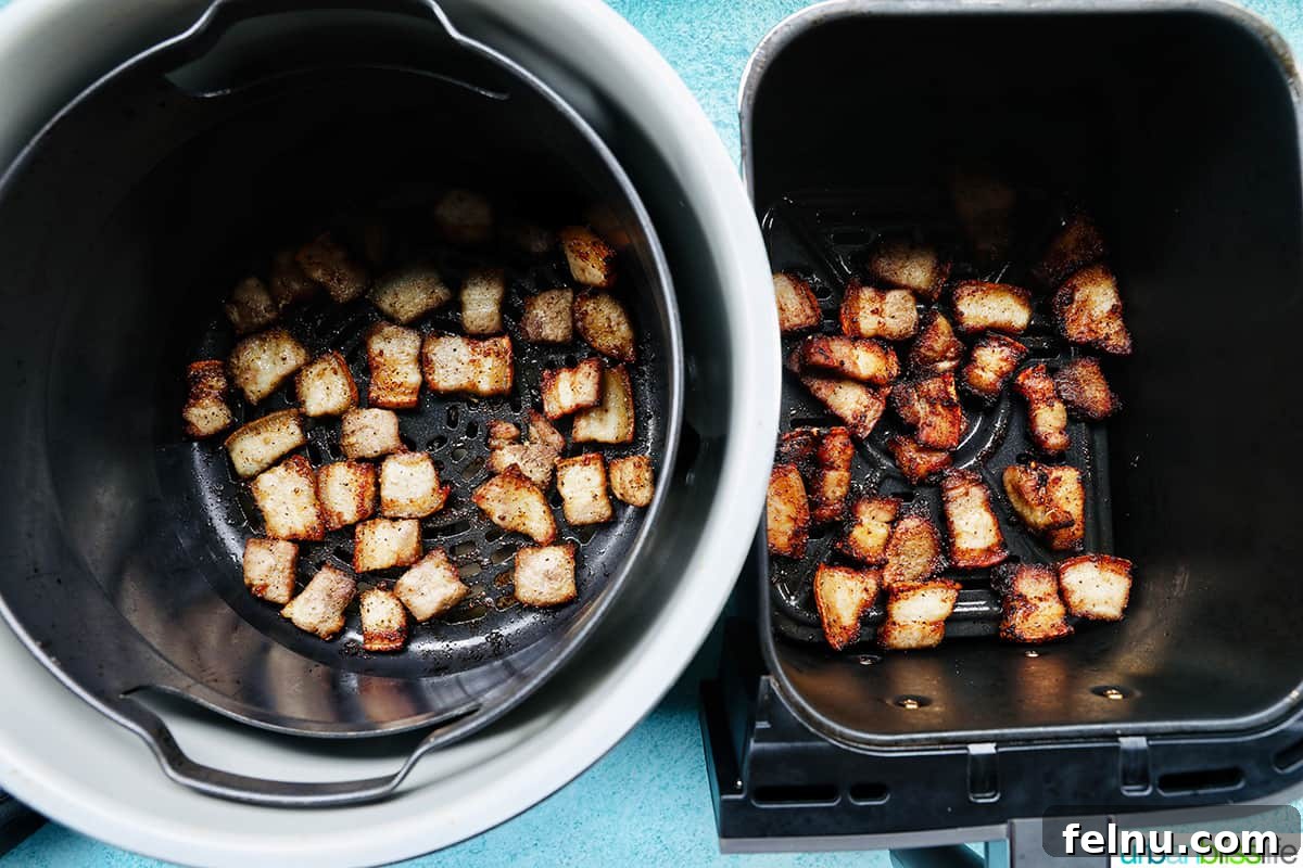 Crispy Air Fryer Pork Belly Bites 9 pork belly cooking in the Ninja Foodi Deluxe XL pressure cooker and in the Ninja Foodi Dual Zone air fryer side by side.