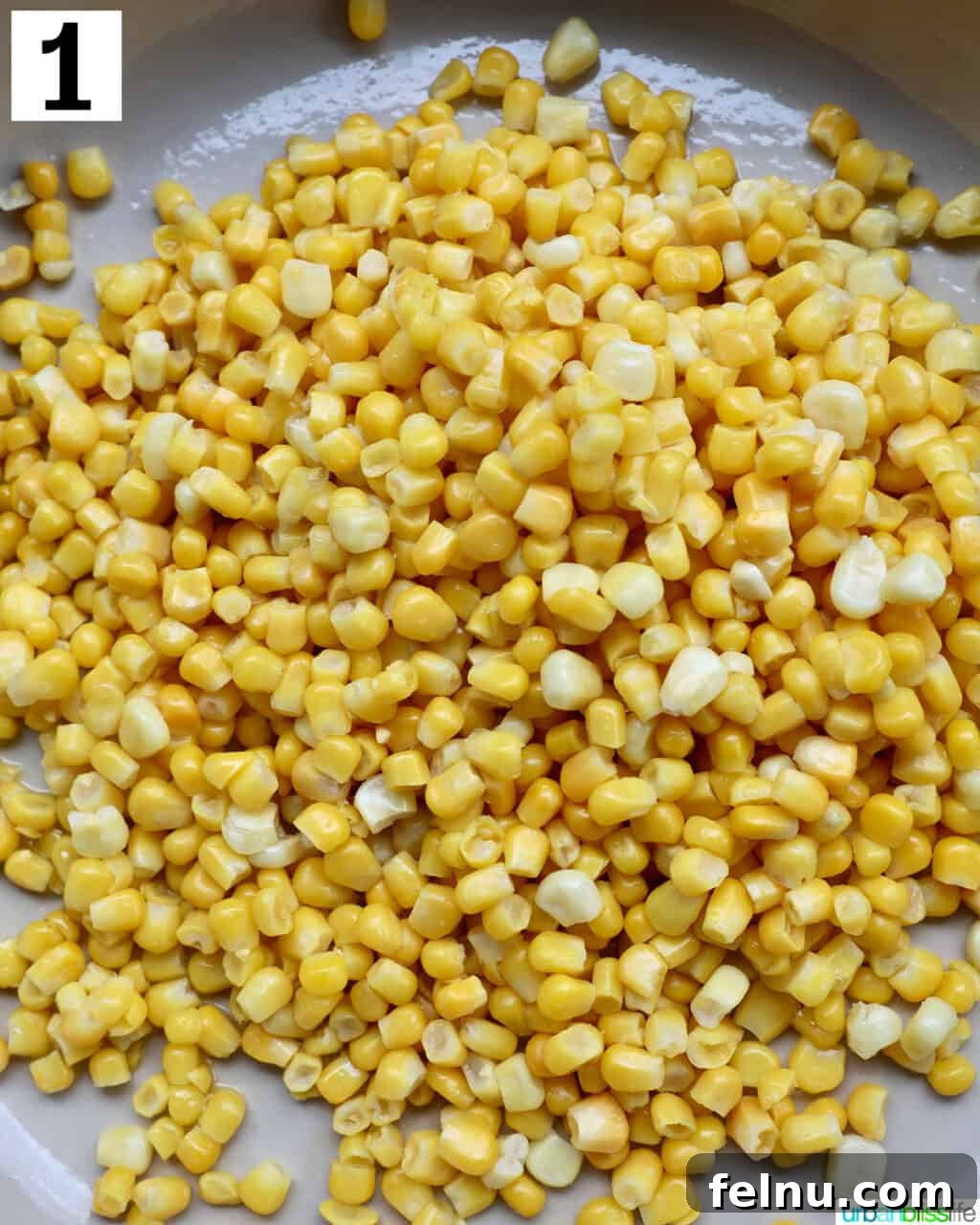 Mexican Street Corn Fiesta Dip 5 Corn kernels cooking in a large saucepan, gently sizzling as they heat up.