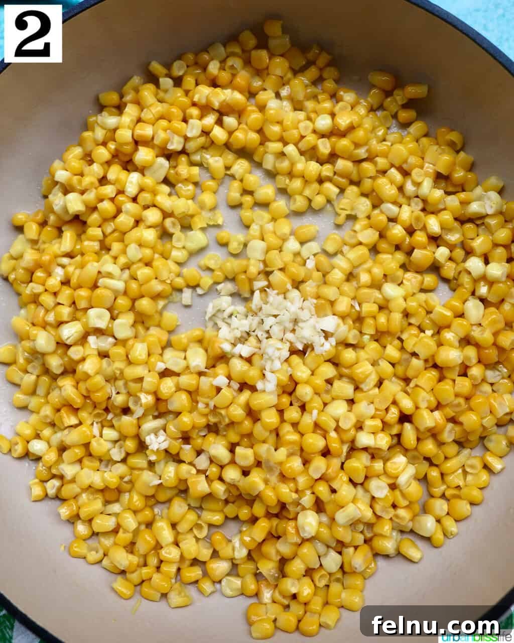 Mexican Street Corn Fiesta Dip 6 Corn kernels and minced garlic sautéing together in a large saucepan, releasing aromatic steam.