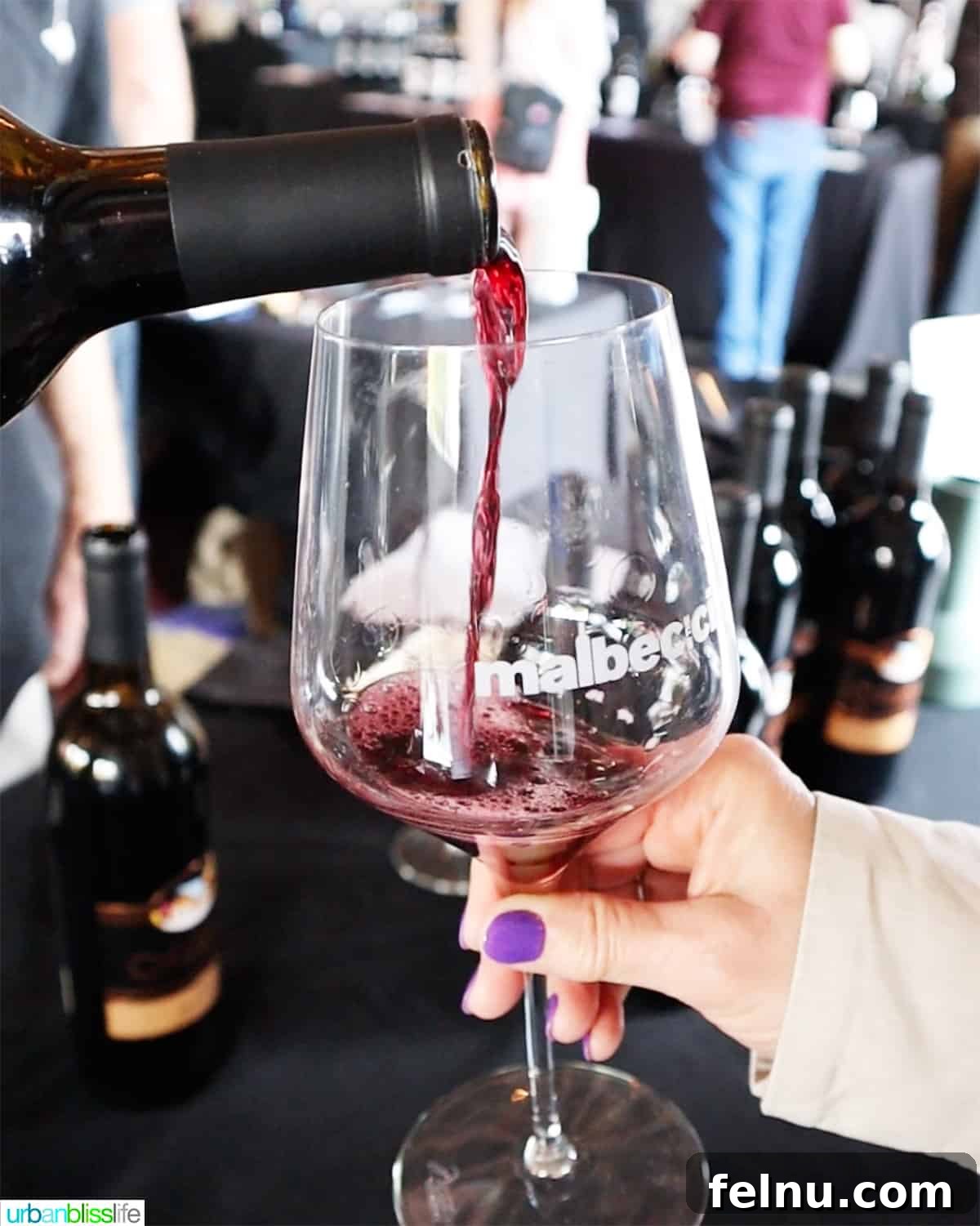 Malbec Takes Root: Oregon's Unexpected Wine Story 2 Malbec in the City logo glass with red wine pouring in the glass.
