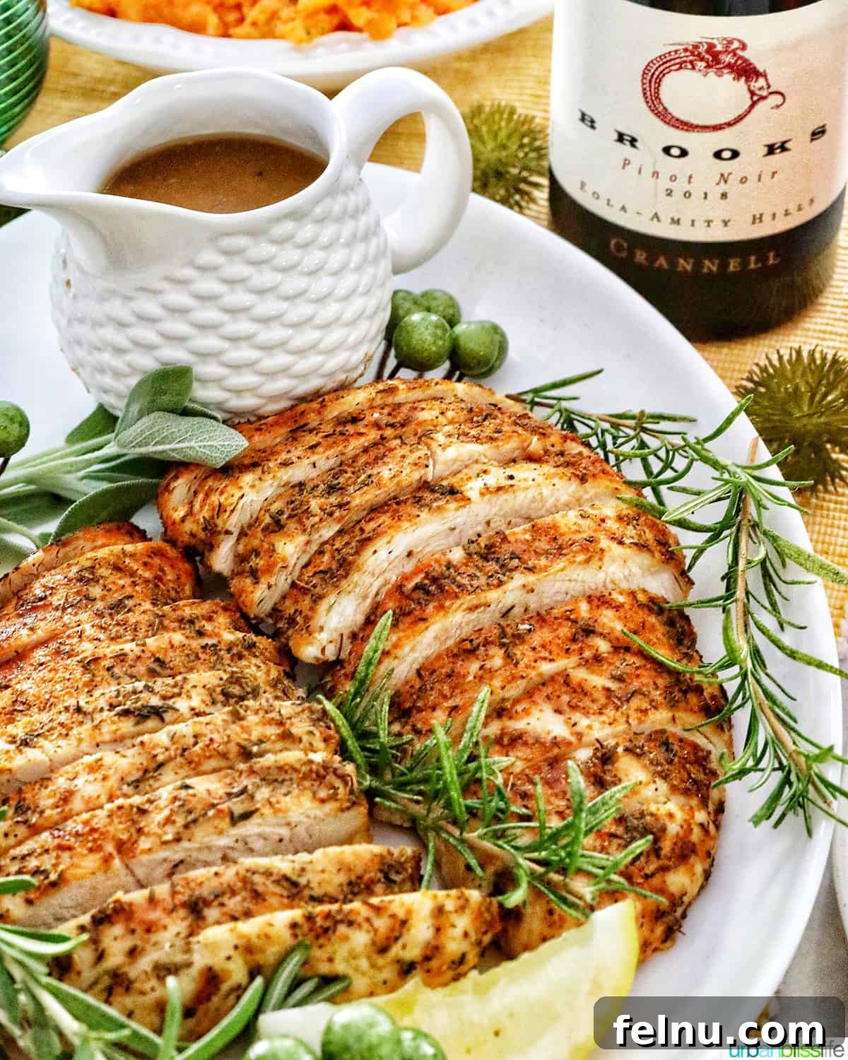 The Perfect Pairing: Wine and Turkey 3 A beautifully plated dish of sliced turkey tenderloin, accompanied by classic sides like gravy and sweet potatoes, and a bottle of perfectly paired wine.