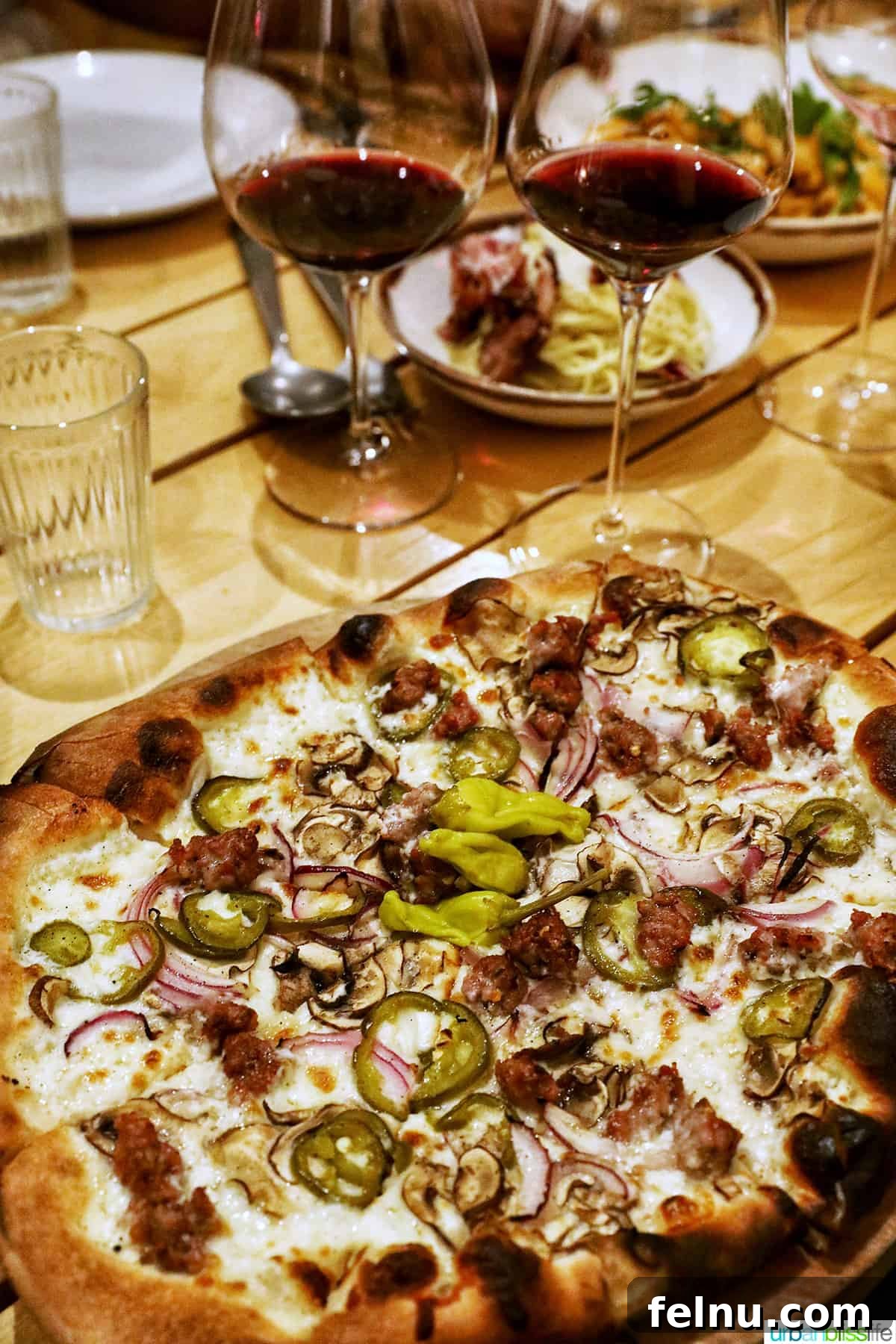 Pairing Pizza Perfection: The Ultimate Wine Guide 9 Two glasses of red wine with a mushroom pizza, showcasing the earthy richness of the pairing.