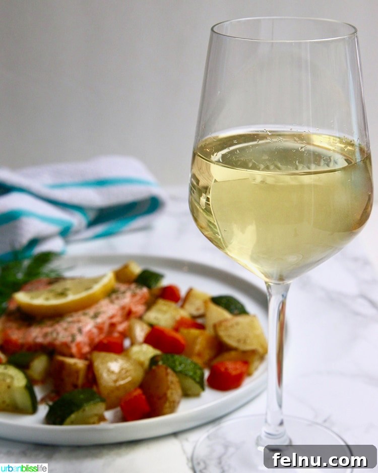 Chardonnay's Culinary Companions 7 Sheet Pan Salmon and Vegetables served alongside a glass of wine.