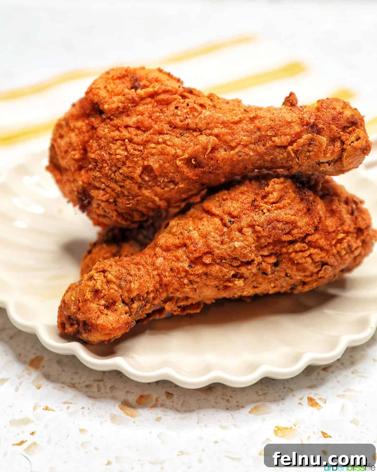 Sauvignon Blanc: The Perfect Food Partner 12 Two fried chicken drumsticks stacked on a scalloped plate