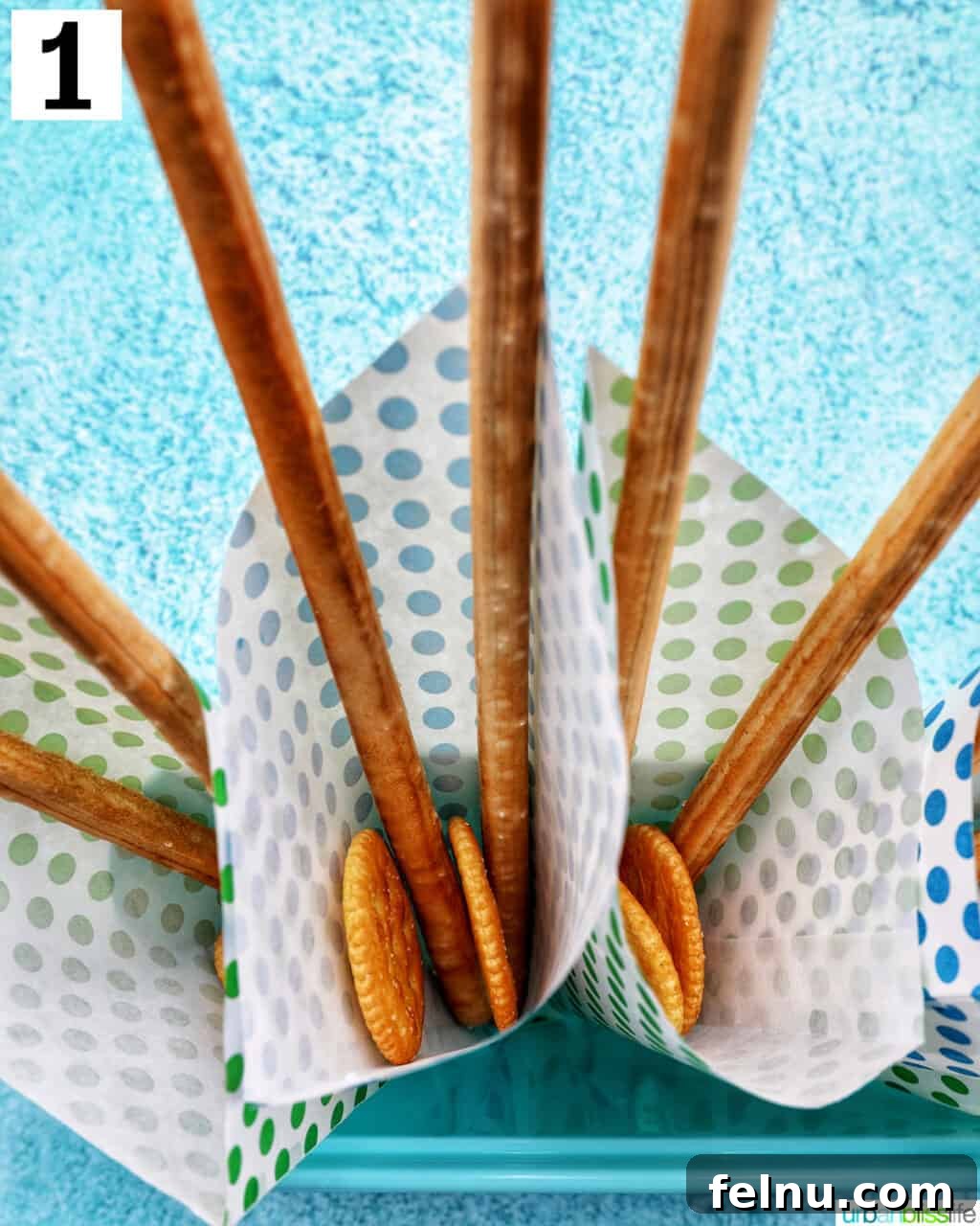 Charcuterie on the Go 6 Paper cones with breadsticks and crackers at the bottom.