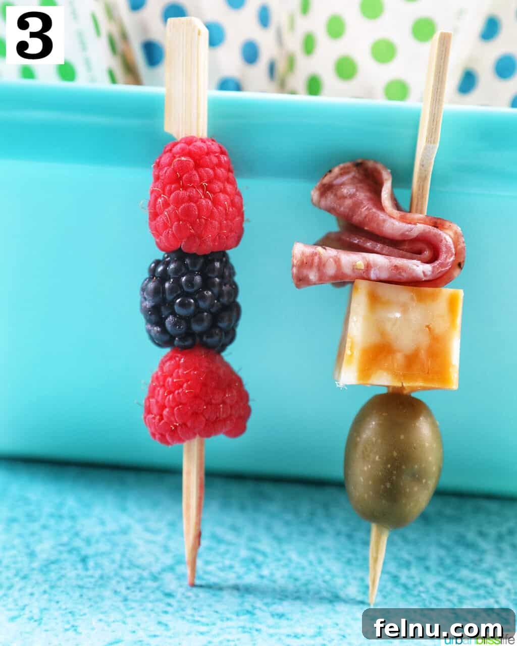 Charcuterie on the Go 8 Food skewers with salami, cheese, and olives, and a food skewer with fruit.
