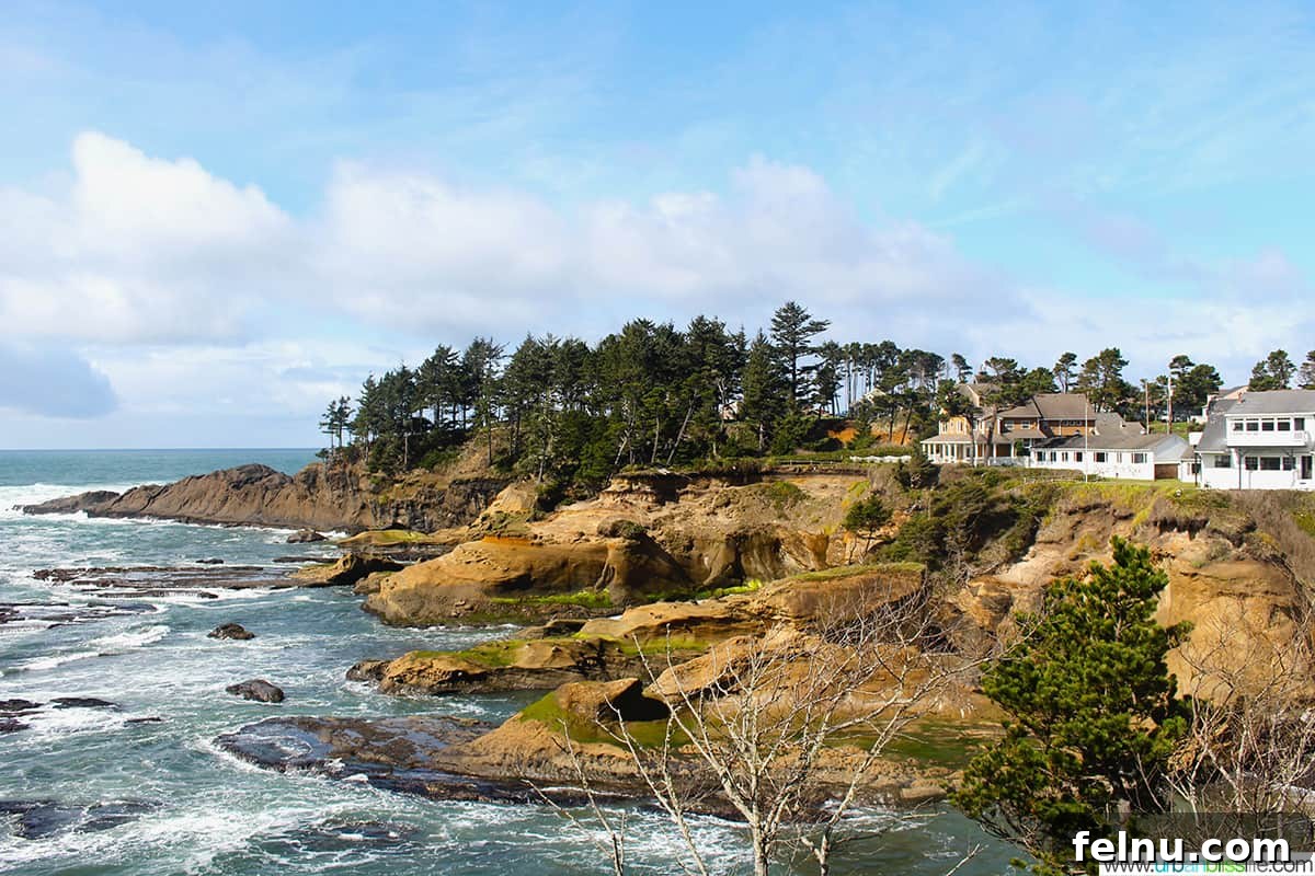 Quintessential Oregon Coast Towns 6 Depoe Bay, Oregon - photo of waves against the shore and a large white building overlooking the ocean.