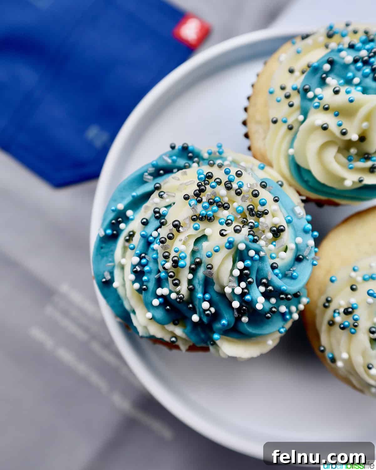 Effortless Vanilla Bean Buttercream 8 Vanilla cupcakes with blue and white buttercream frosting