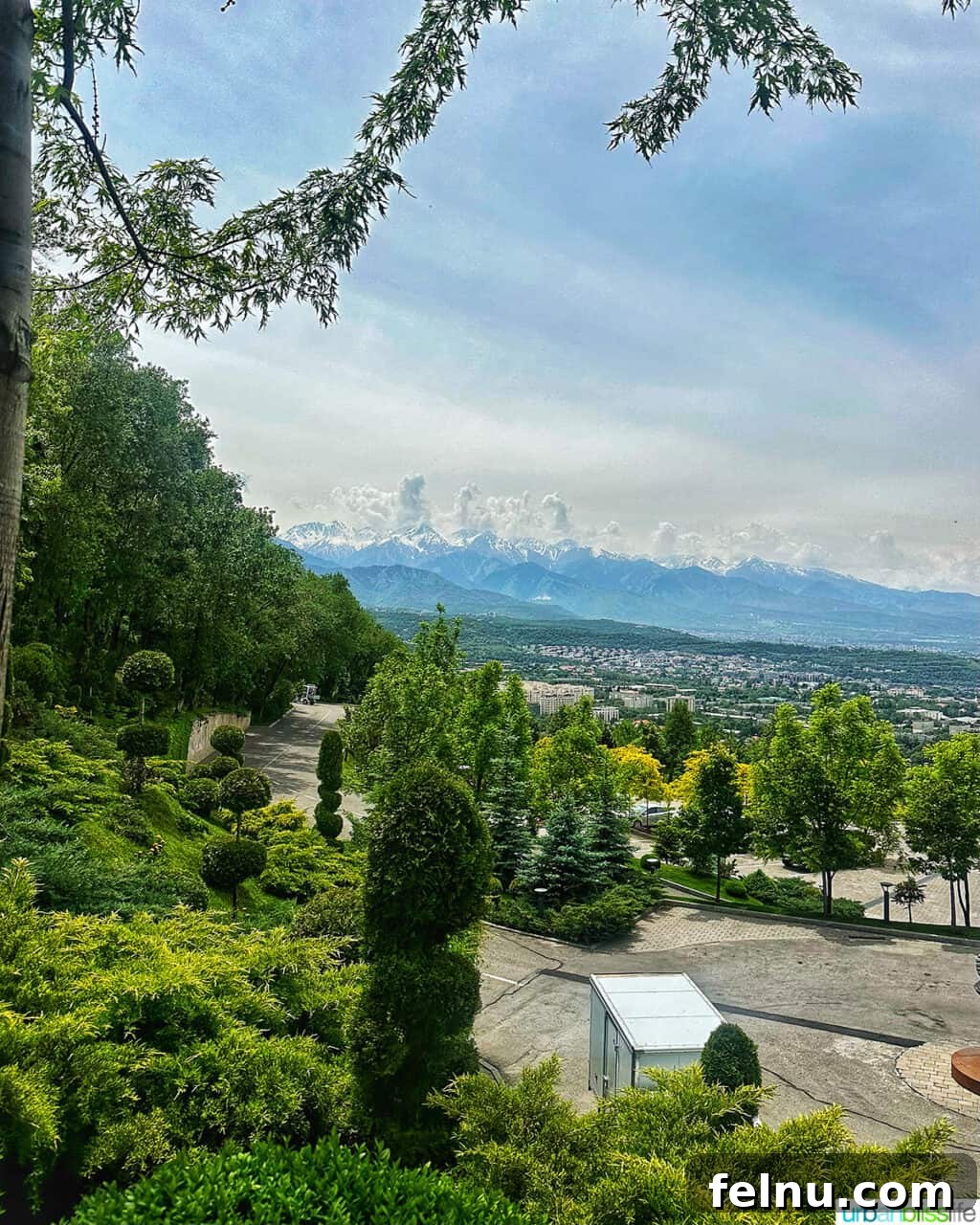 Explore Almaty: Thirty Unforgettable Things to Do 12 A breathtaking panoramic view of Almaty, Kazakhstan, as seen from the scenic vantage point of Kok Tobe hill, with mountains in the distance.
