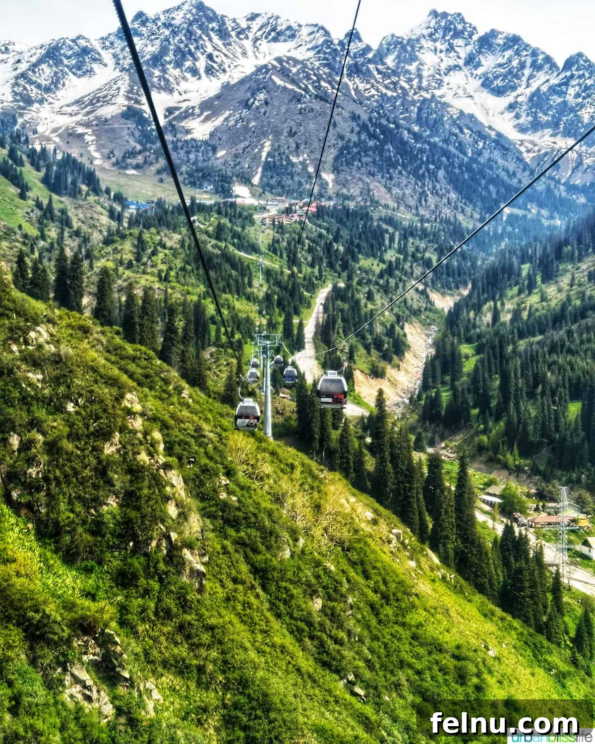Explore Almaty: Thirty Unforgettable Things to Do 13 The impressive Shymbulak Ski Resort nestled amidst snow-capped mountains in Almaty, Kazakhstan, featuring a gondola system.
