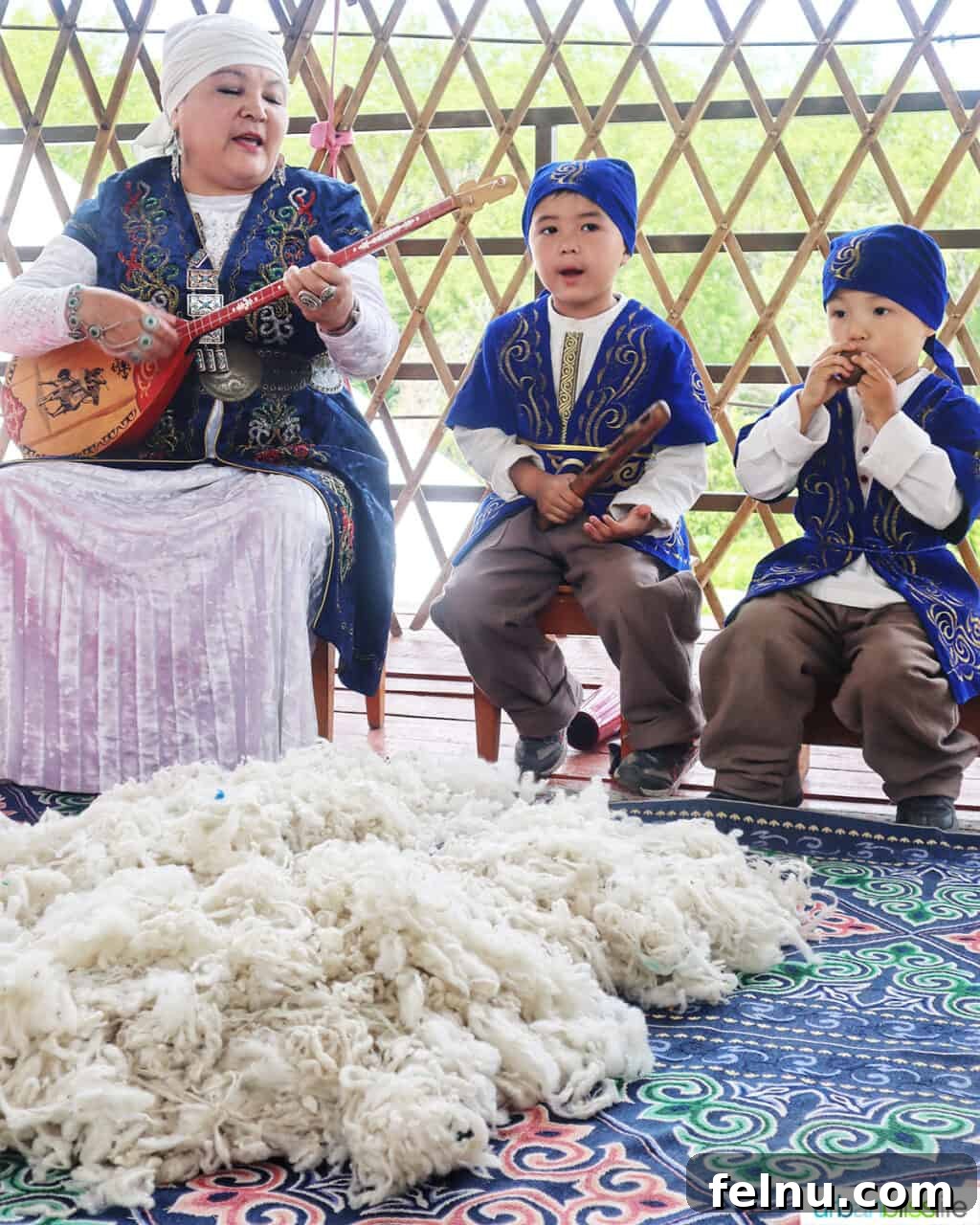 Explore Almaty: Thirty Unforgettable Things to Do 24 A woman and two children play traditional musical instruments at the Ethno Village of the Huns near Almaty, Kazakhstan, showcasing cultural heritage.