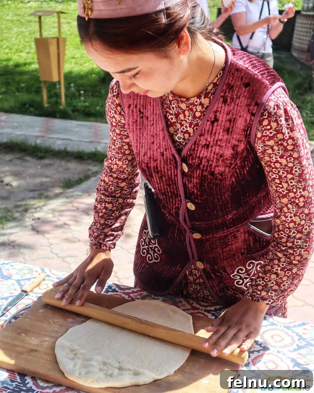 Explore Almaty: Thirty Unforgettable Things to Do 25 A woman skillfully rolls out dough to prepare baursak, a traditional Kazakh bread, at the Ethno Village of the Huns near Almaty, Kazakhstan.