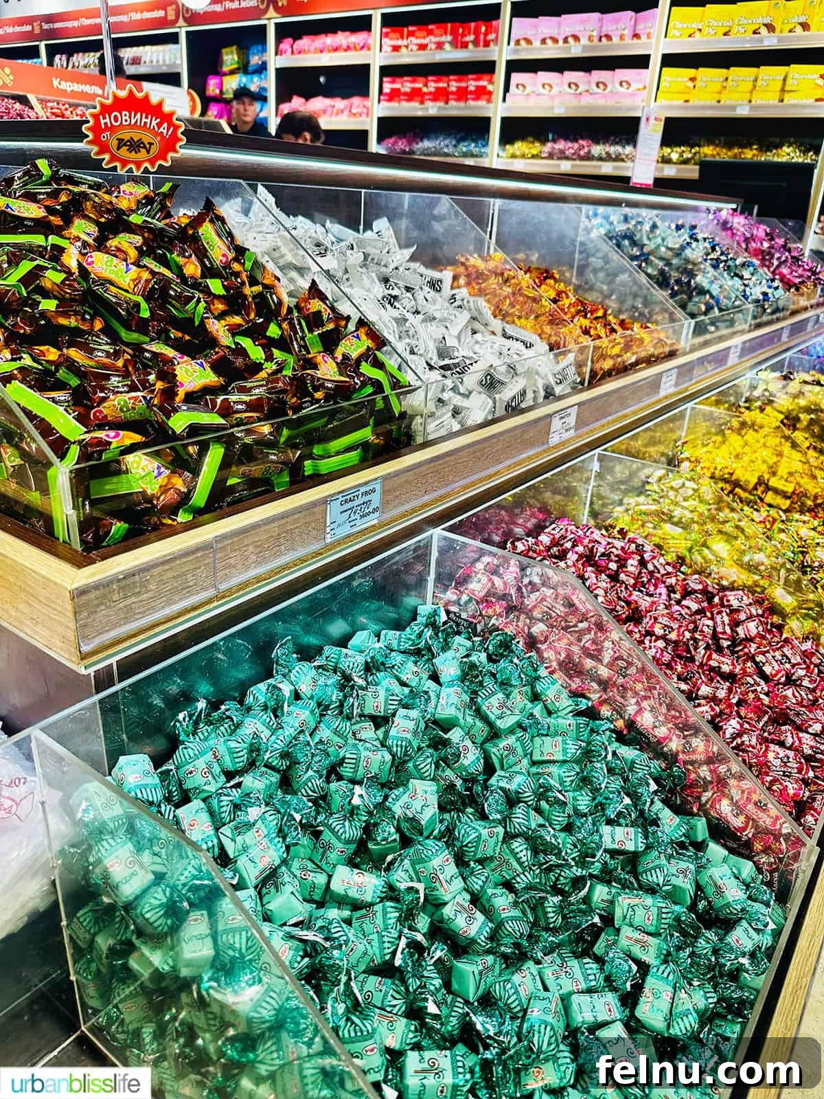 Explore Almaty: Thirty Unforgettable Things to Do 31 Bins overflowing with colorfully wrapped chocolates at the Rakhat Chocolate Factory store in Almaty, Kazakhstan, a treat for chocolate lovers.