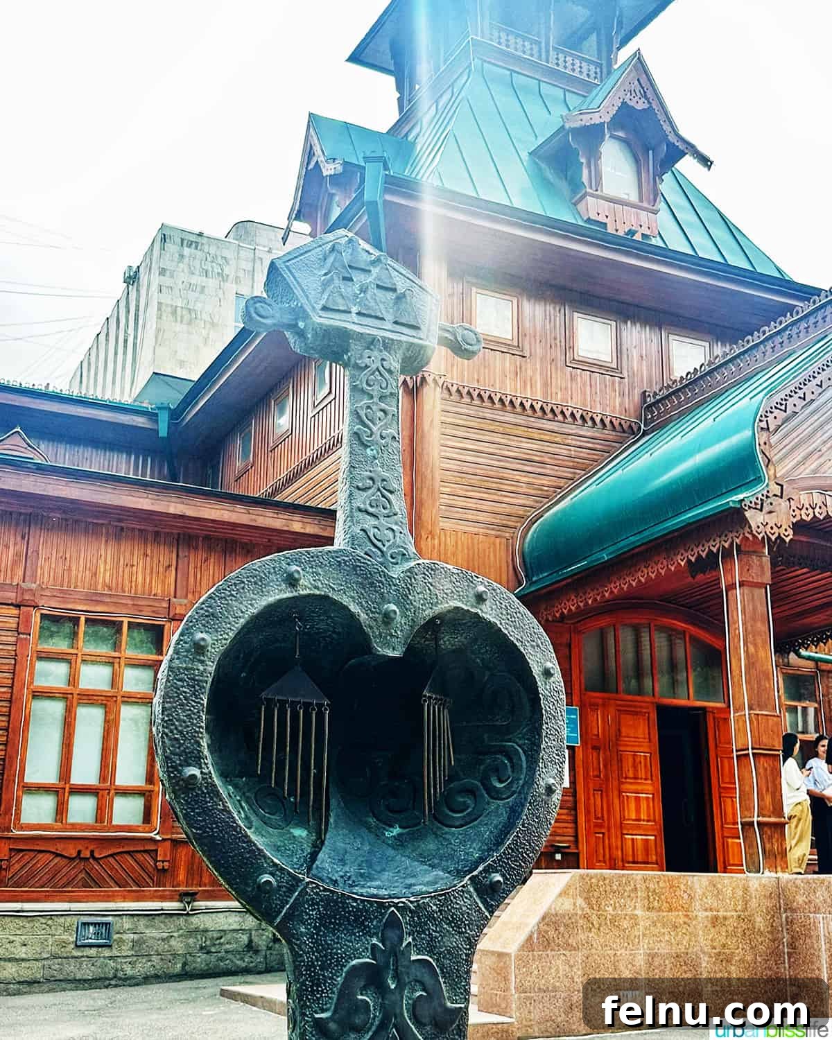 Explore Almaty: Thirty Unforgettable Things to Do 36 The unique architecture of the Kazakh Museum of Folk Musical Instruments in Panfilov Park, Almaty, featuring wood and green elements.