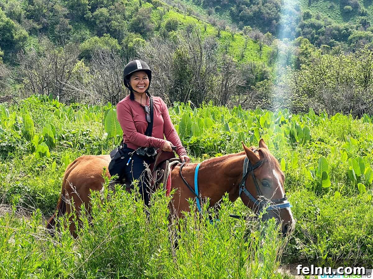 Explore Almaty: Thirty Unforgettable Things to Do 37 Marlynn horseback riding amidst scenic mountain trails at Oi Qaragai Resort outside of Almaty, Kazakhstan.