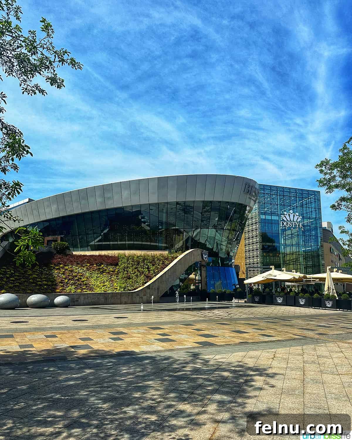 Explore Almaty: Thirty Unforgettable Things to Do 39 The grand exterior of Dostyk Plaza, one of Almaty's premier shopping malls, showcasing modern architecture.