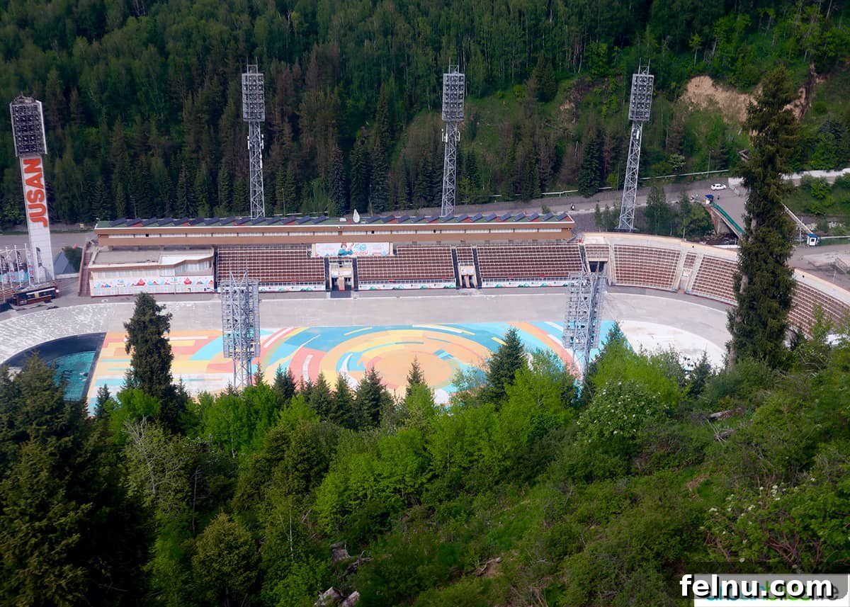 Explore Almaty: Thirty Unforgettable Things to Do 41 An expansive view of the Medeu Ice Skating Rink, seen from a gondola high above, showcasing its impressive scale and mountain setting.