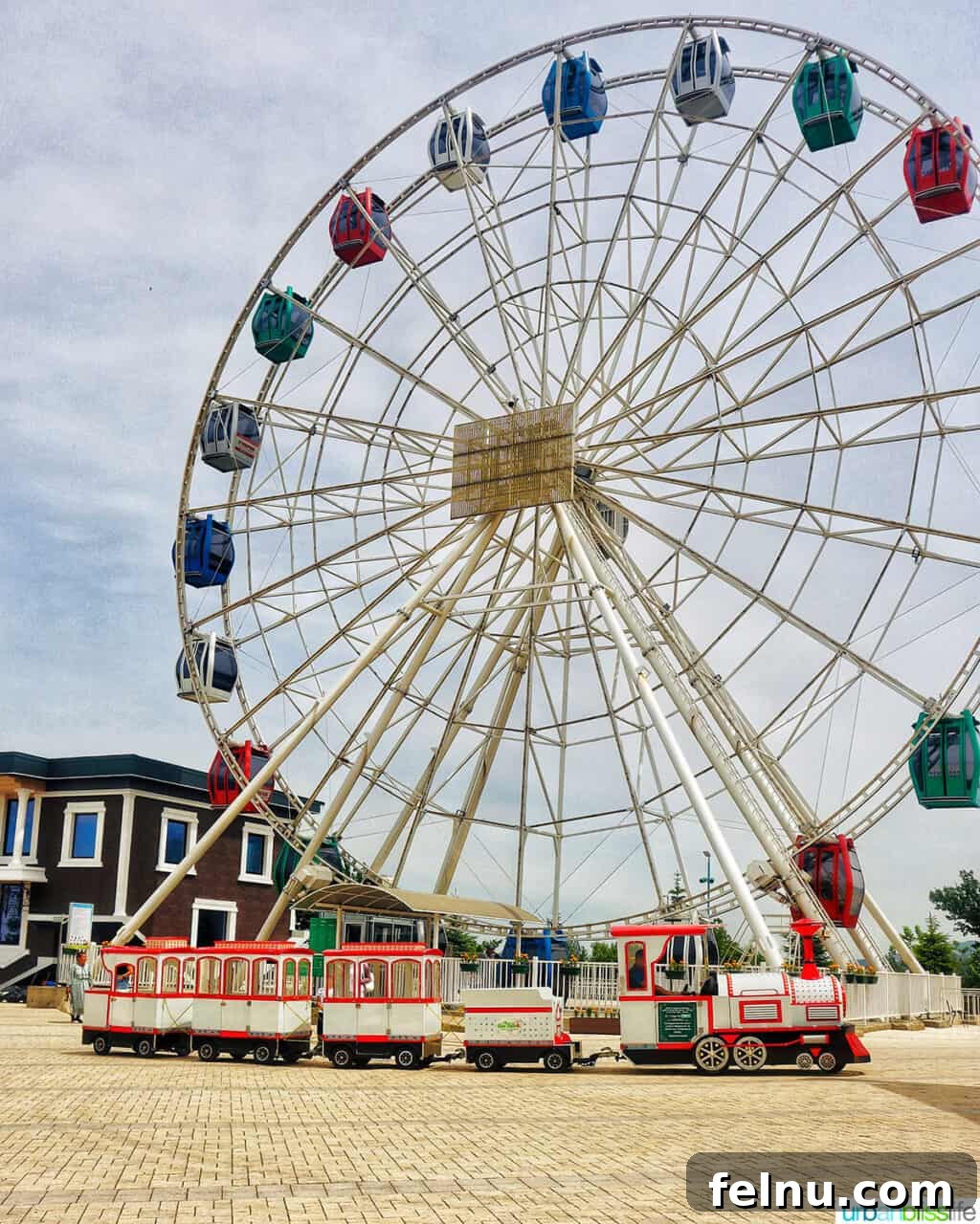 Explore Almaty: Thirty Unforgettable Things to Do 10 A large, colorful Ferris wheel dominates the skyline at Kok Tobe hill in Almaty, Kazakhstan, part of the family-friendly amusement park.