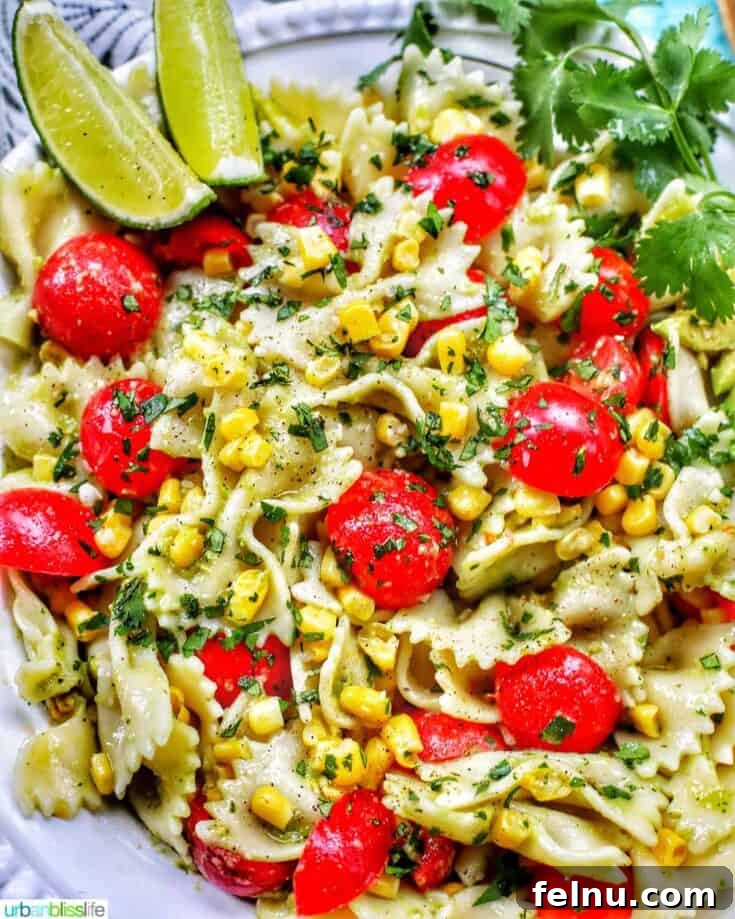 Avocado pasta salad with tomatoes and corn.