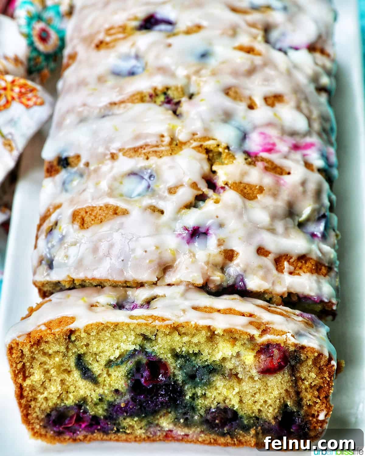 Lemon blueberry pound cake slices on a plate, showcasing the moist crumb and blueberry distribution.