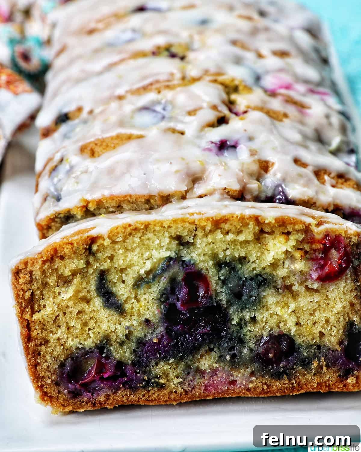 Slices of lemon blueberry pound cake served on a plate, highlighting the moist texture and vibrant blueberries.
